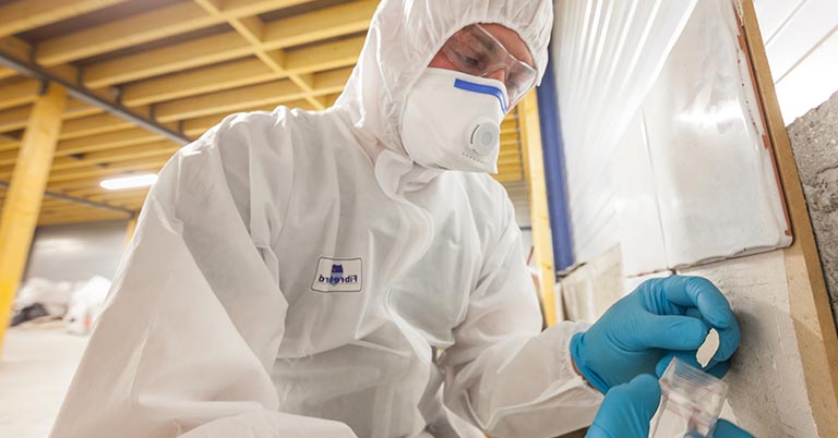 asbestos tester taking a sample in a building