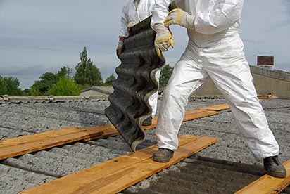 asbestos worker removing materials from a roof
