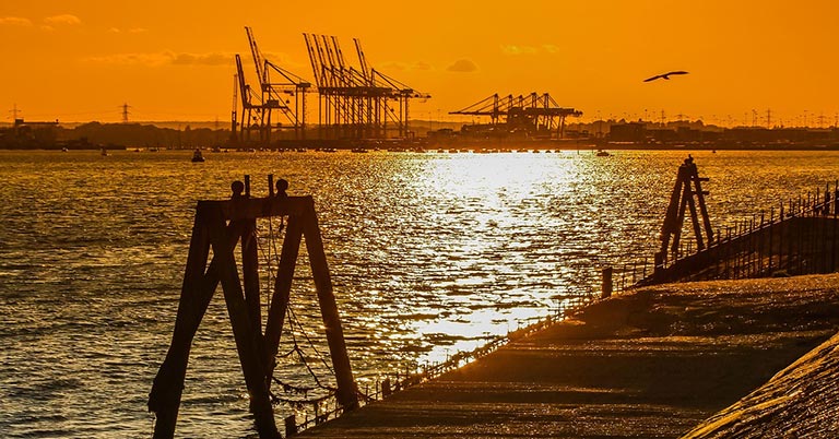 southampton docks with cranes in the distance at dusk
